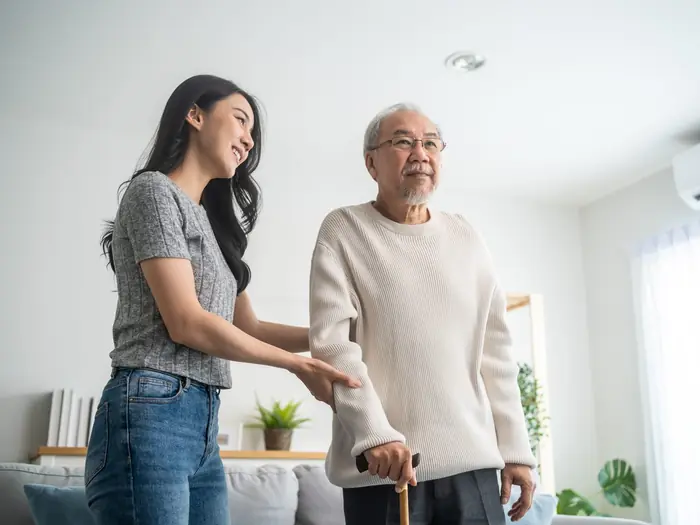 A daughter helping her father at home